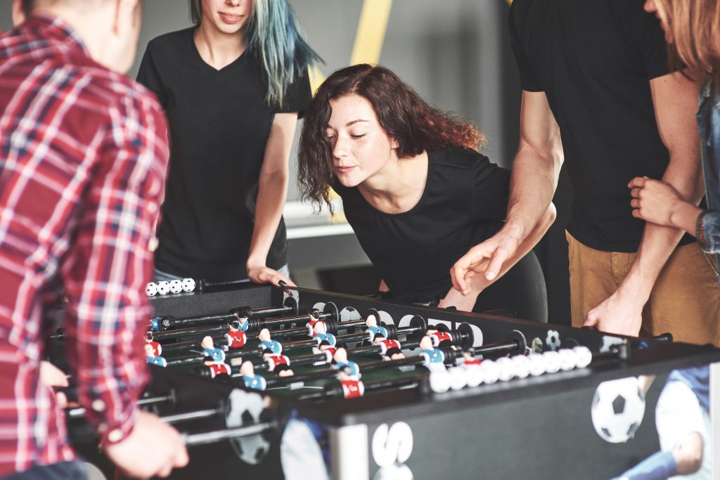 Friends together play board games, table football.